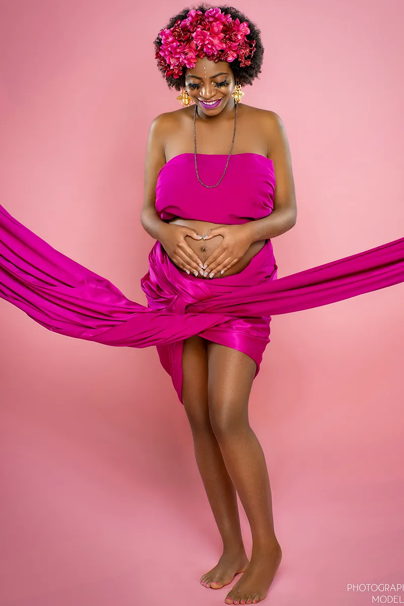 Maternity portrait with pink fabric wrap on pink backdrop - SJRIMAGES